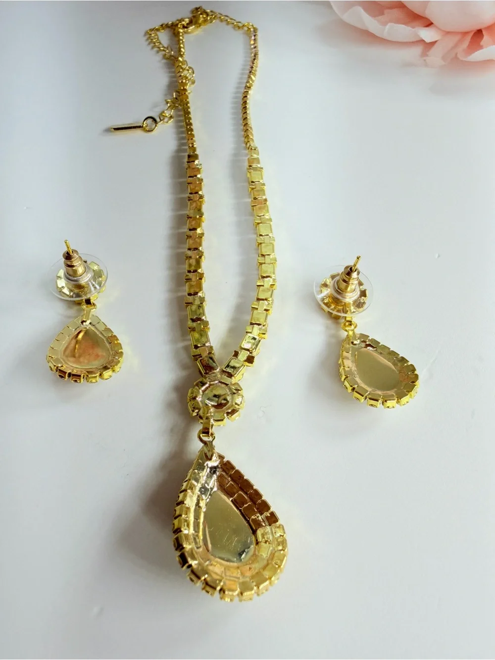 Elegant gold-tone necklace with earrings featuring a white teardrop pearl pendan